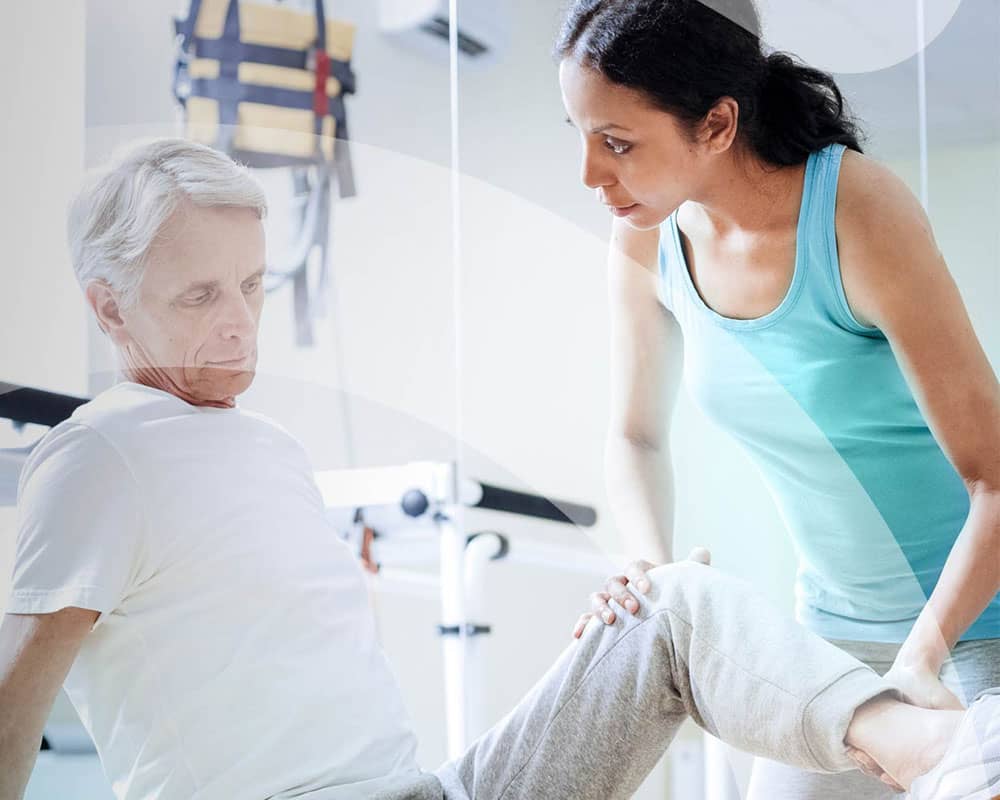 Physiotherapist helping elderly male